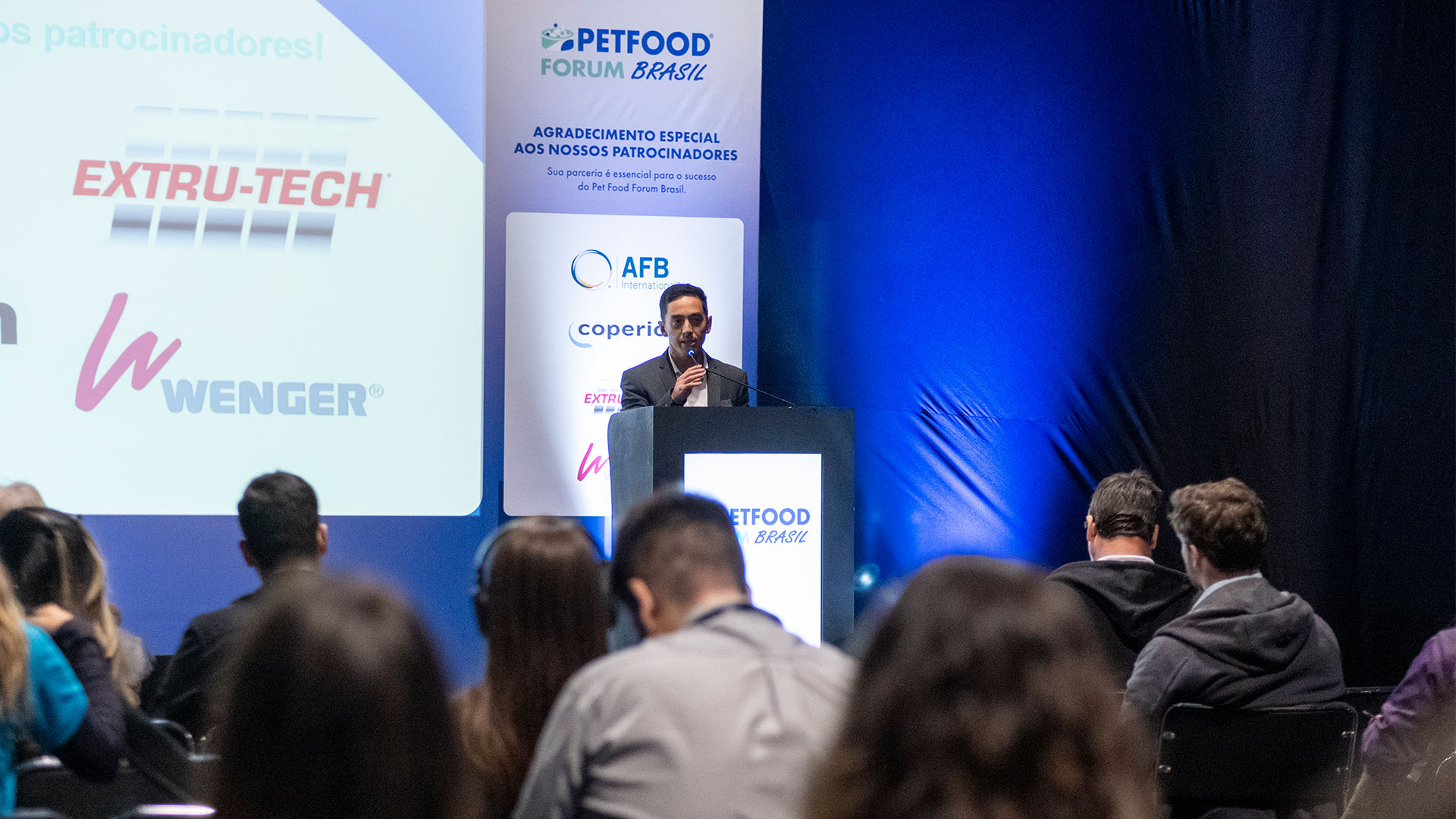 Male speaker speaking at podium during Petfood Forum Brasil